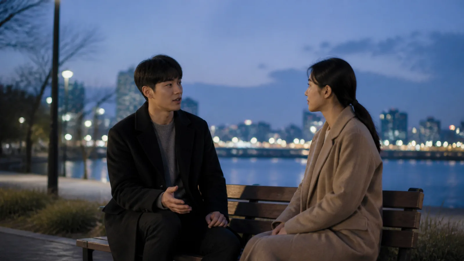 저녁 강변 벤치에서 차분하게 서로의 마음을 이야기하는 두 사람